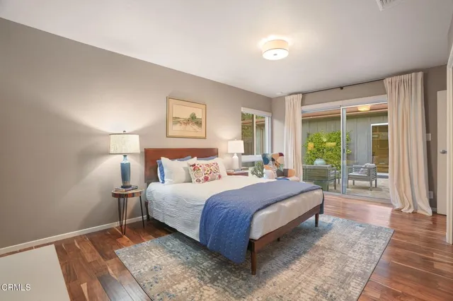 a bedroom with a large bed and a night stand