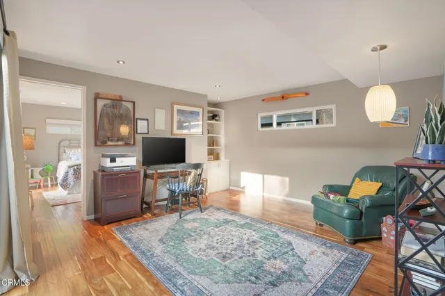 a living room with furniture and a wooden floor
