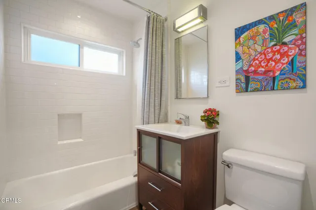 a bathroom with a sink mirror vanity and toilet