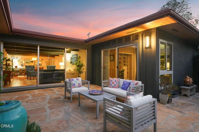 a patio with patio couch and a dining table