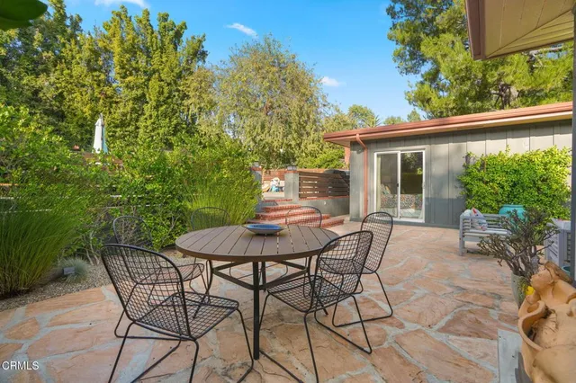 a view of a chairs and table in the patio