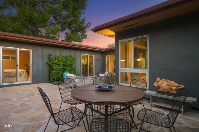 a view of a patio with a table and chairs
