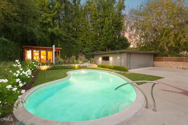 a swimming pool with outdoor seating and yard