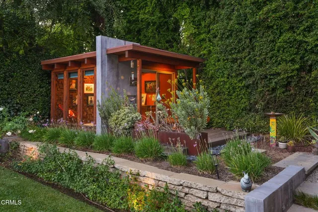 a front view of a house with garden