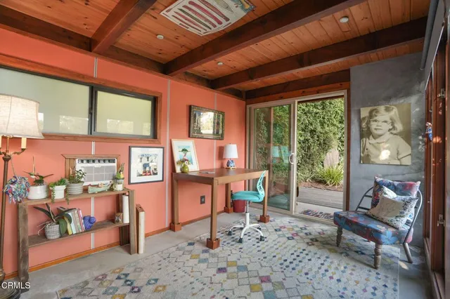 a living room with furniture a rug and a large window