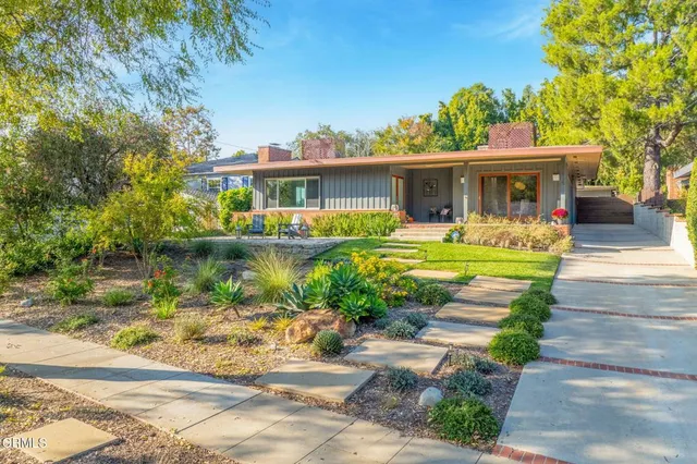 a front view of a house with a yard table and chairs