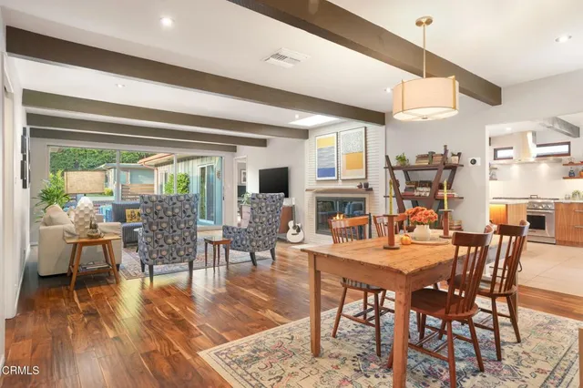 a dining room with furniture window and wooden floor