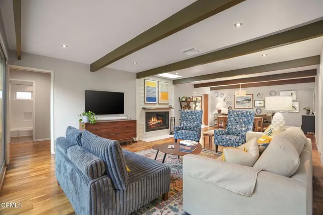 a living room with fireplace furniture and a flat screen tv