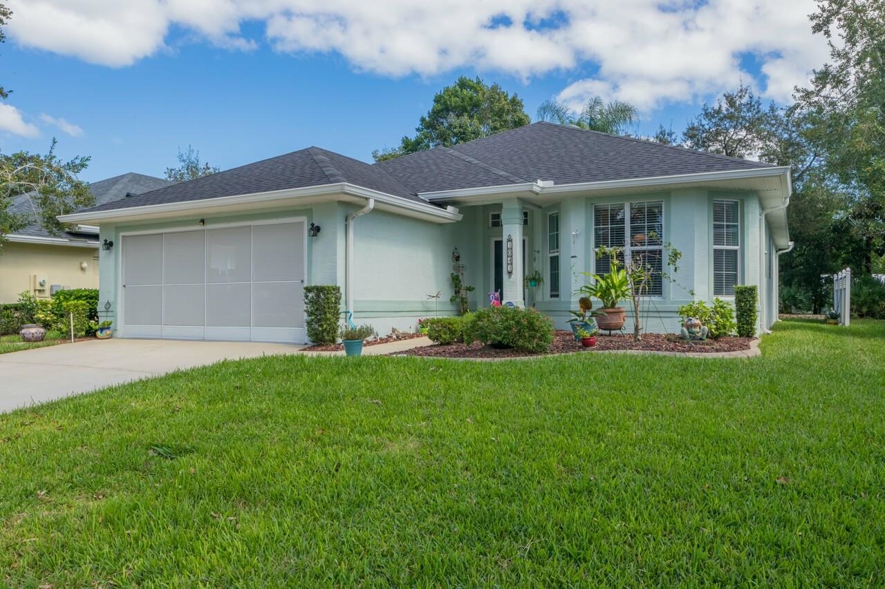 a front view of a house with a garden and plants