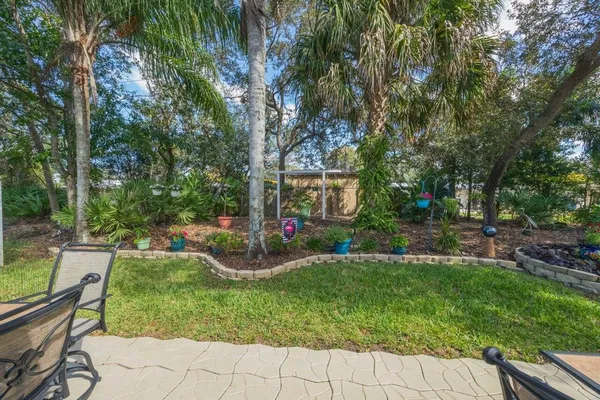 a view of a chair and table in the garden