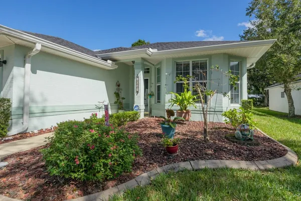 a front view of a house with garden