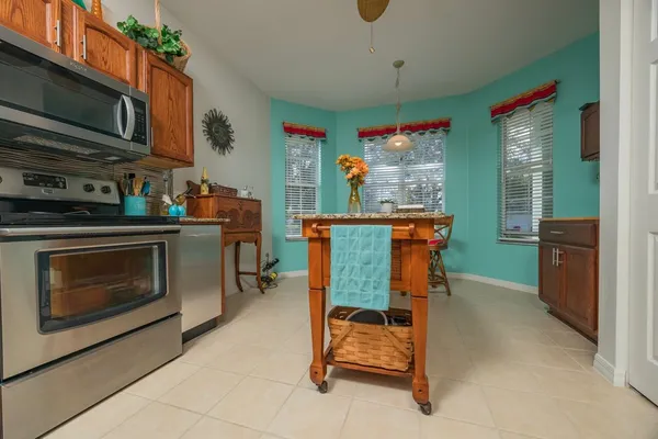 a kitchen with granite countertop a stove and a microwave