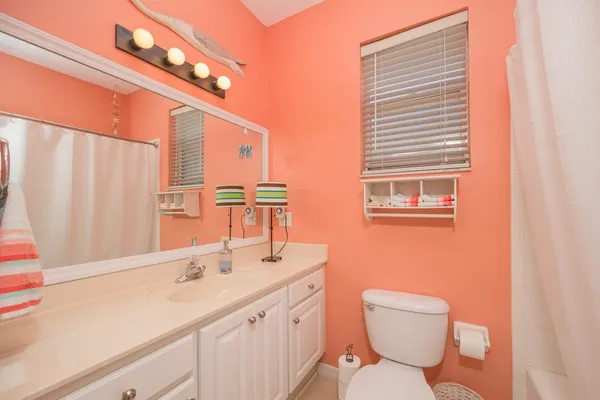 a bathroom with a toilet a sink and a window