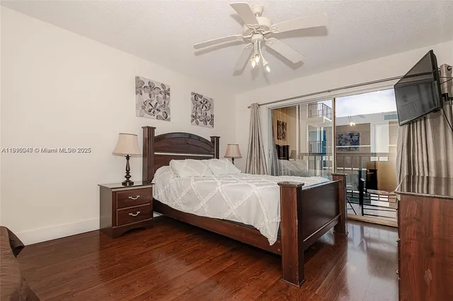 a bedroom with a bed flat screen tv and a couch