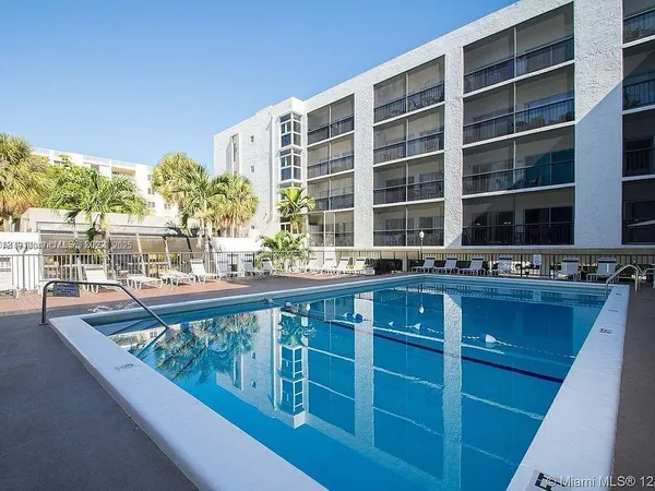 a kitchen with a large counter top a sink and dishwasher