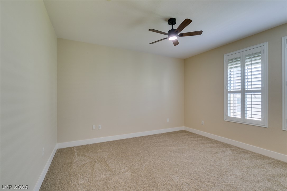 2555 Hampton Road, Unit 3203 Henderson, NV 89052 - Photo 35 of 43 Plush carpeting anchors this versatile room detailed with plantation shutters.