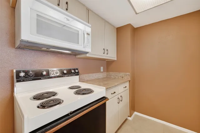 a kitchen with a stove and a microwave