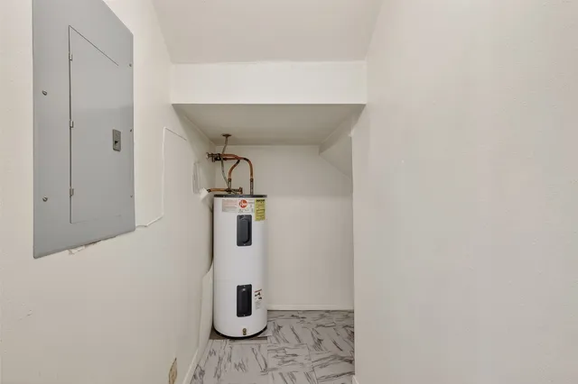 an empty room with a ceiling fan and a window