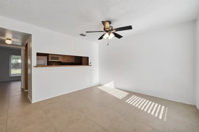 a view of a room with a ceiling fan