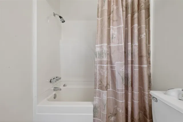 a bathroom with a shower and a tub