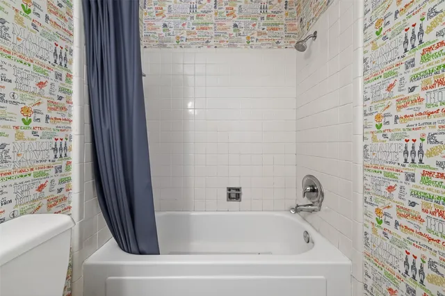 a bathroom with a tub and a shower curtain