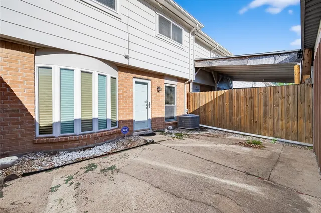 a backyard of a house with outdoor seating