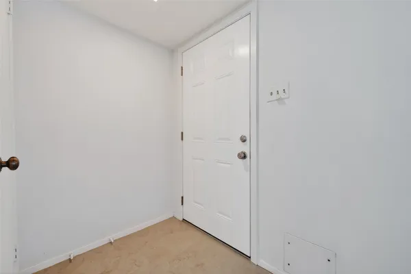 a view of an empty room and a window