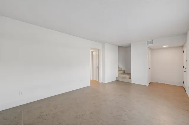 a view of an empty room and a window