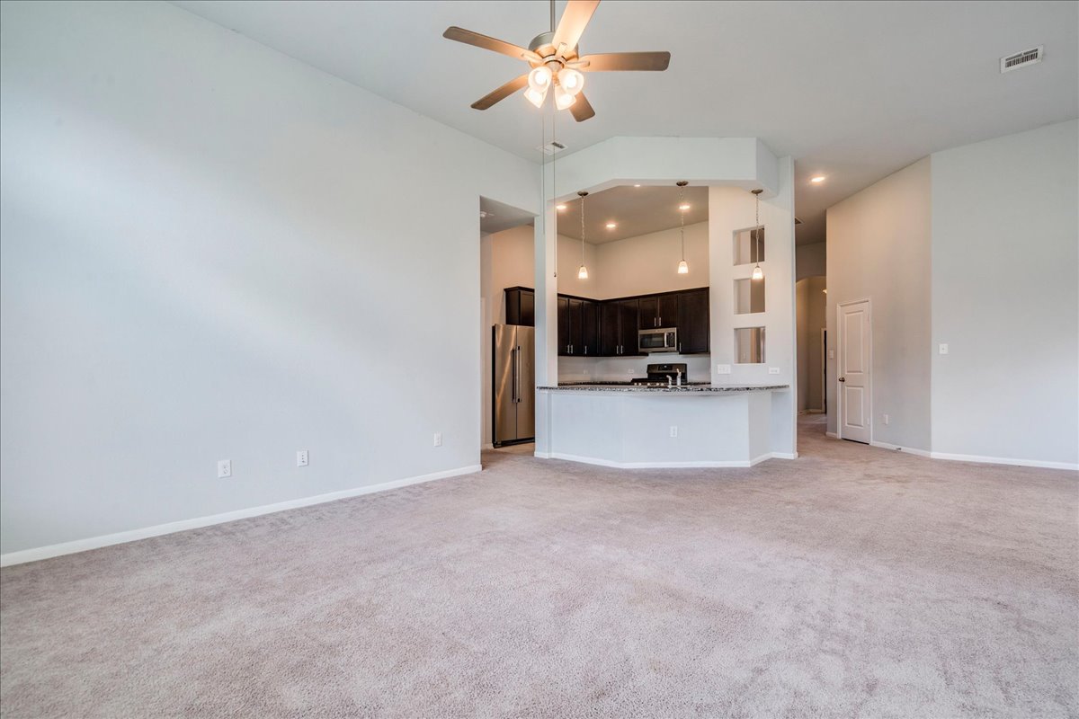 275 Cherrystone Loop Buda, TX 78610 - Photo 16 of 33 Living area open to the kitchen