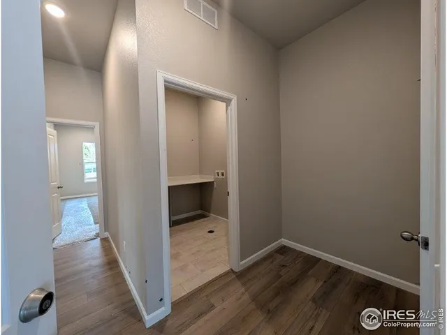 a view of hallway with wooden floor