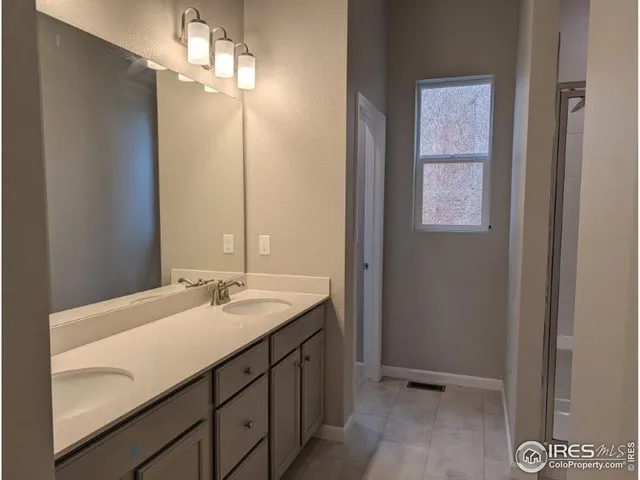a bathroom with a sink vanity and a mirror