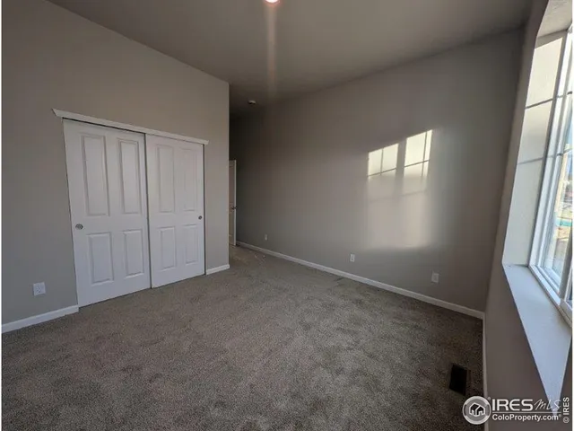 an empty room with windows and stairs