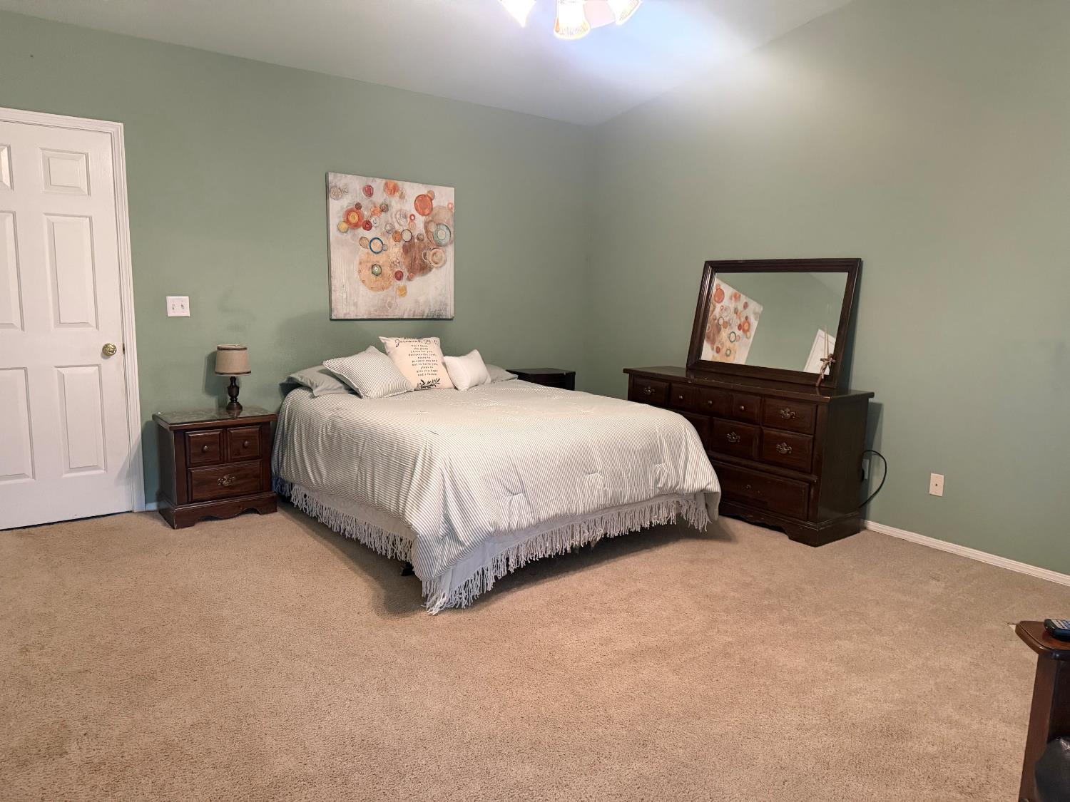 16638 Mark Road Madera, CA 93636 - Photo 18 of 22 a bedroom with a bed and dresser