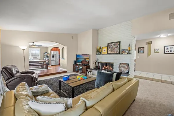 a living room with furniture and a fireplace