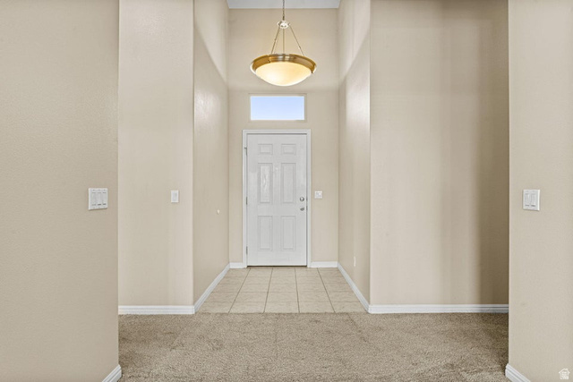 2226 East 140 South St. George, UT 84790 - Photo 3 of 20 Entryway featuring a white paneled door with an overhead transom window, a dome-shaped pendant light, neutral-toned walls, and a tiled floor transition