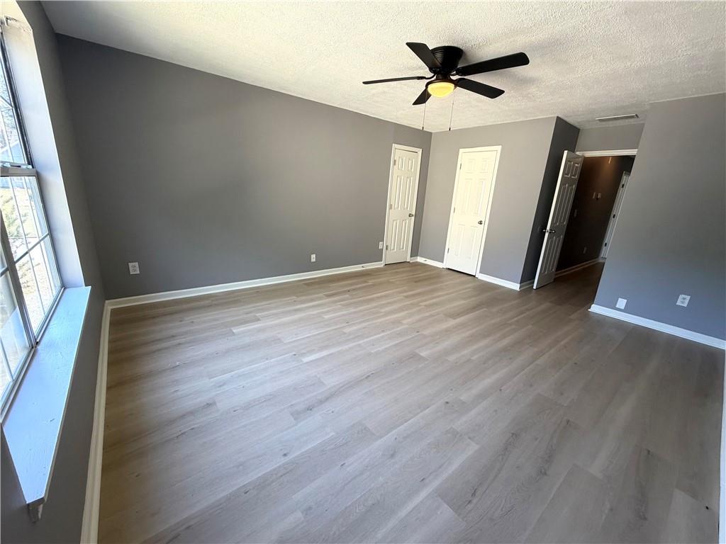 2205 Springer Walk Lawrenceville, GA 30043 - Photo 19 of 26 wooden floor in an empty room with a window