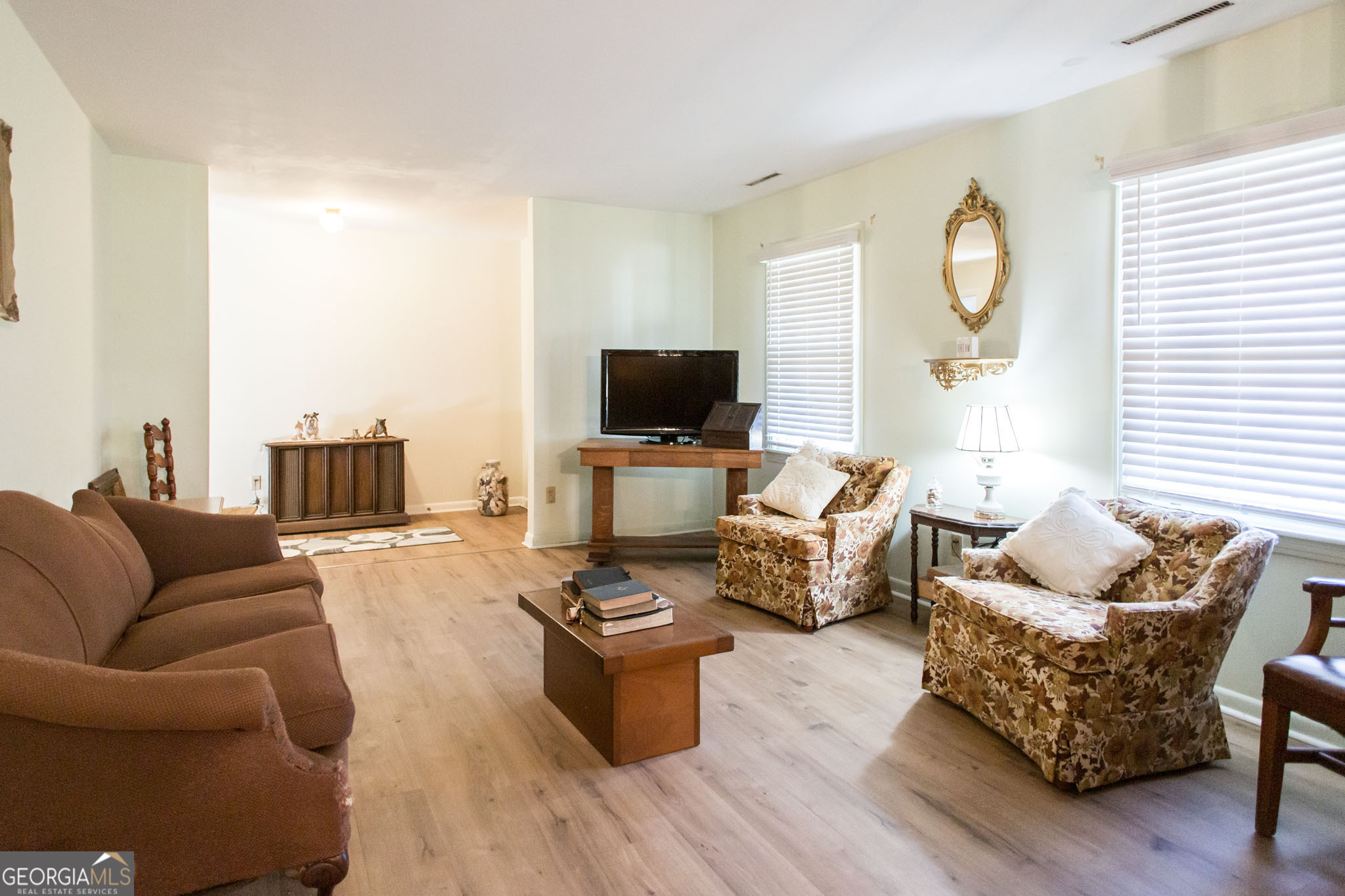 403 Preston Street Waycross, GA 31501 - Photo 13 of 36 a living room with furniture wooden floor and a flat screen tv