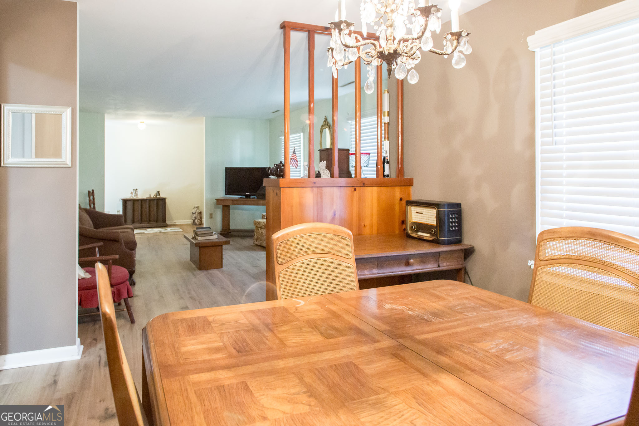 403 Preston Street Waycross, GA 31501 - Photo 24 of 36 a bedroom with furniture and a chandelier