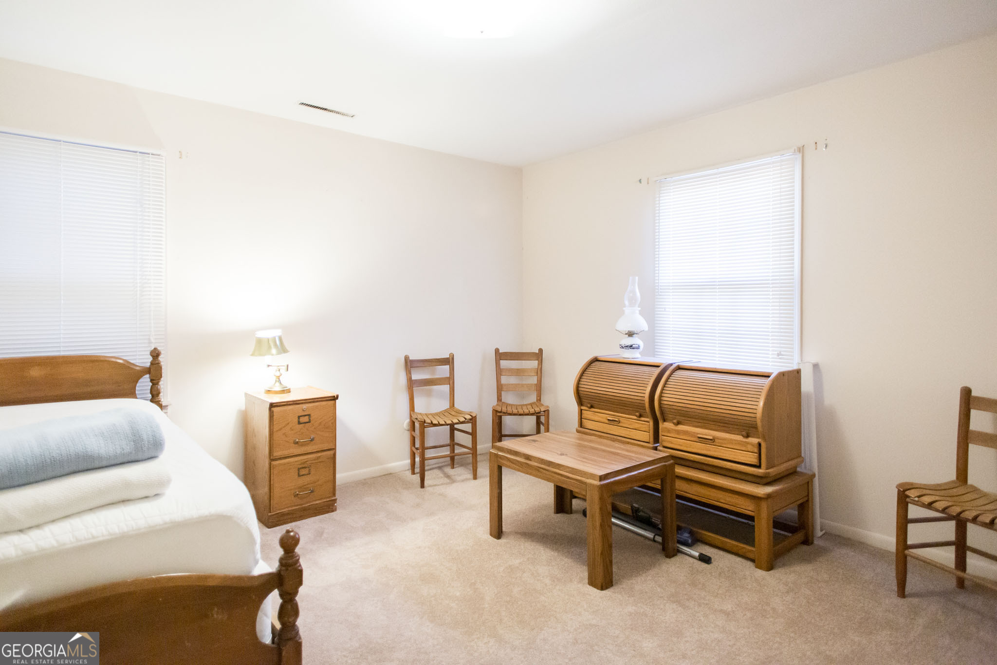 403 Preston Street Waycross, GA 31501 - Photo 29 of 36 a bedroom with furniture and a window
