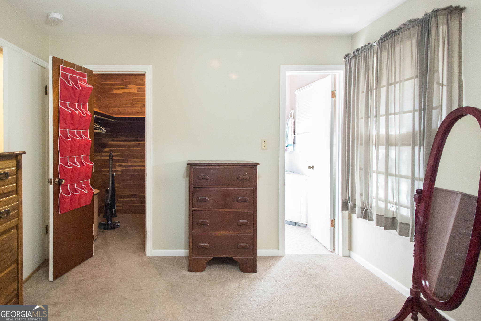 403 Preston Street Waycross, GA 31501 - Photo 32 of 36 a view of an empty room with furniture and a window