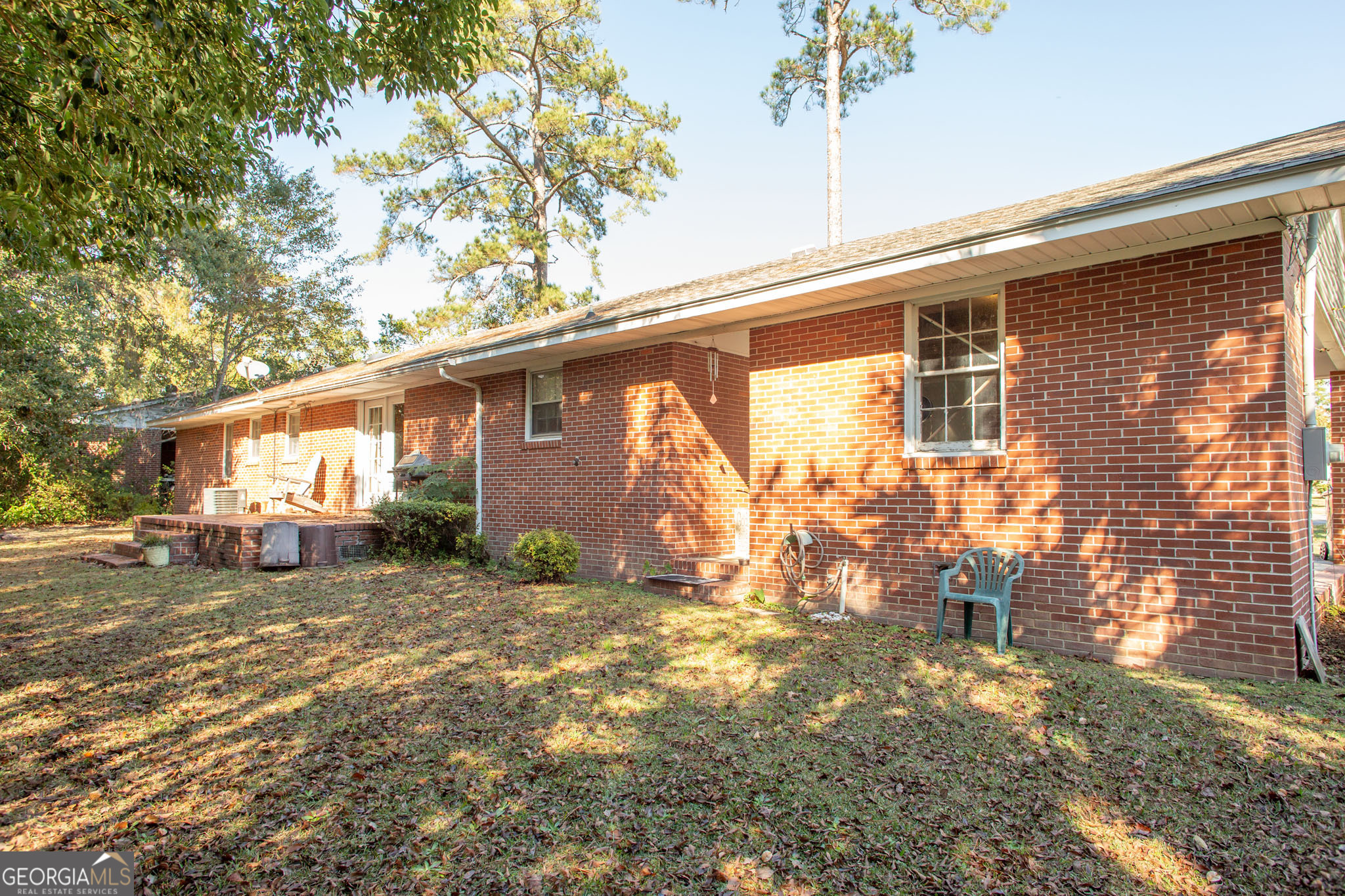 403 Preston Street Waycross, GA 31501 - Photo 9 of 36 a backyard of a house with yard and outdoor seating