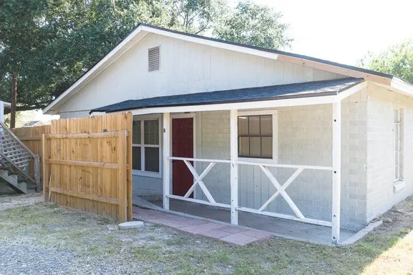 a backyard of a house with table and chairs