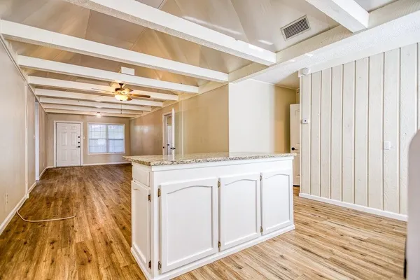 a spacious bathroom with a granite countertop sink and a mirror
