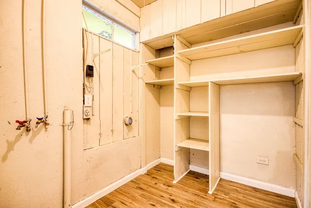 a view of walk in closet with empty racks
