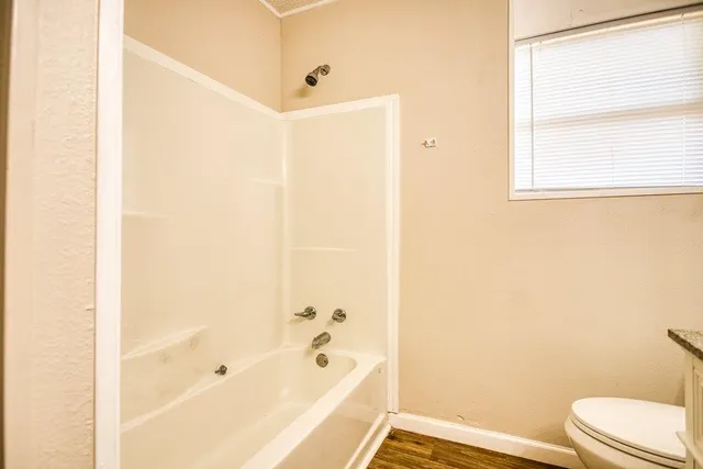 a bathroom with a bathtub and a toilet