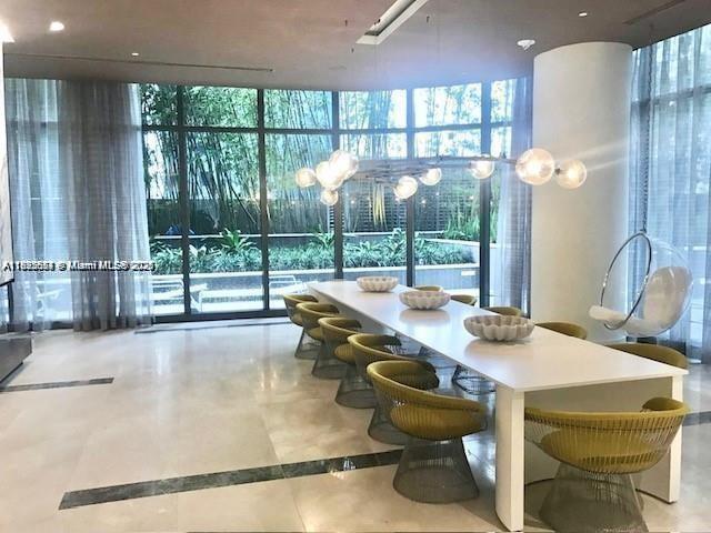 45 Southwest 9th Street, Unit 3009 Miami, FL 33130 - Photo 21 of 35 a dining room with furniture and a floor to ceiling window