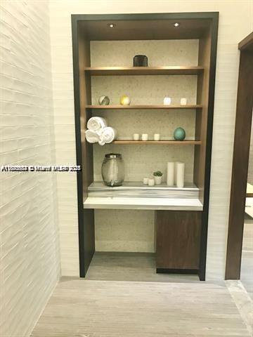 45 Southwest 9th Street, Unit 3009 Miami, FL 33130 - Photo 30 of 35 a room with a wooden cabinet