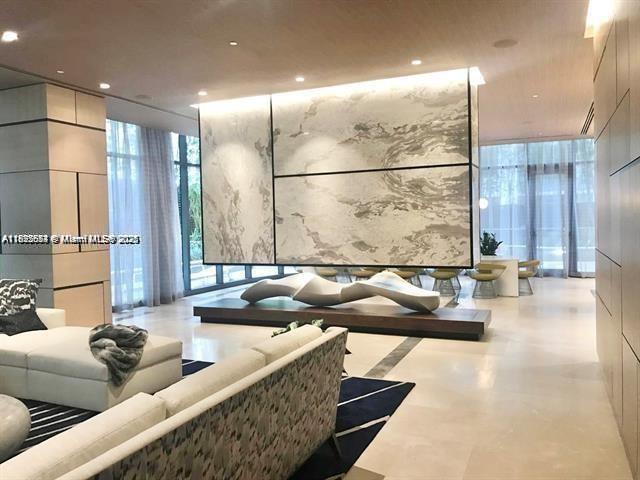 45 Southwest 9th Street, Unit 3009 Miami, FL 33130 - Photo 32 of 35 a living room with couches and kitchen view with wooden floor