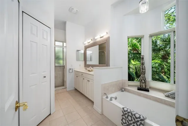 a bathroom with a bathtub sink and mirror