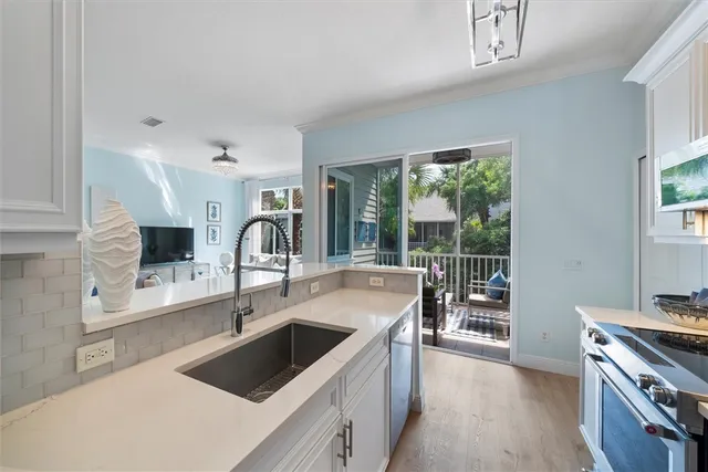 a kitchen with a sink and a stove top oven